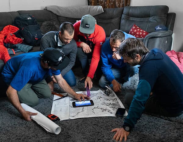 A group looking at a map planning their mountain expedition.